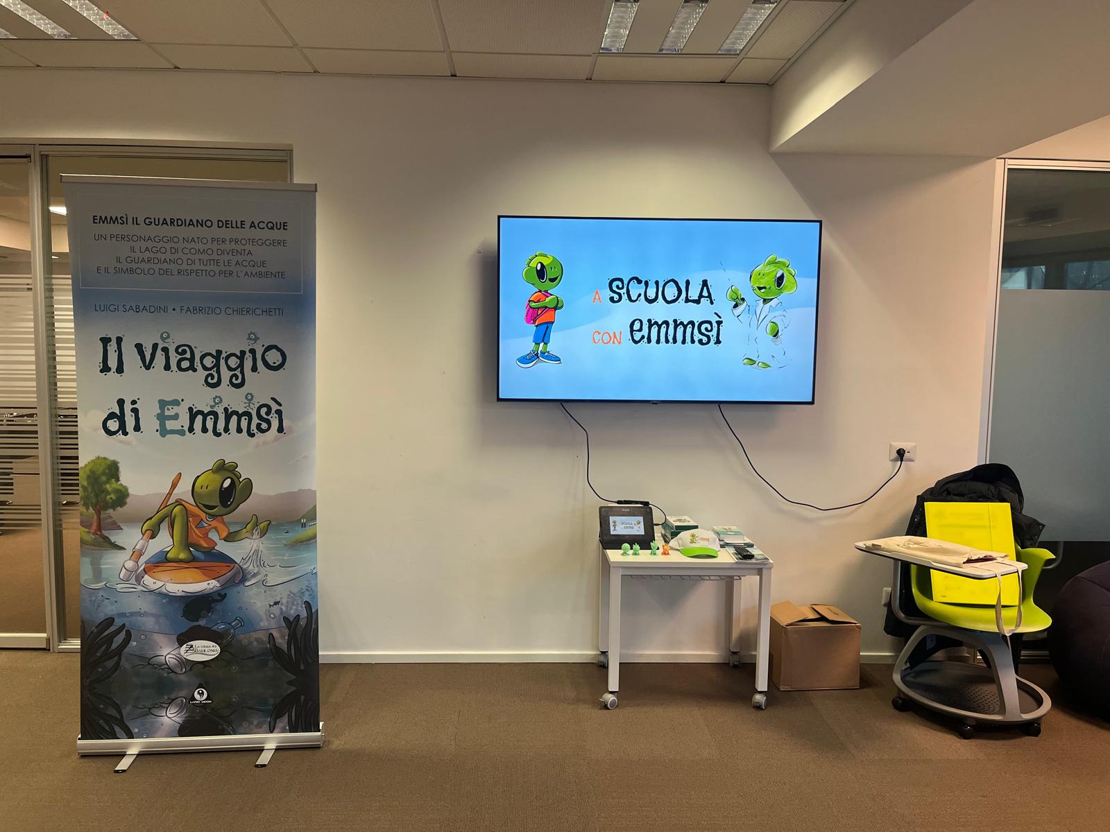 Aula pronta per il laboratorio A scuola con Emmsì, con il roll-up Il viaggio di Emmsì e la LIM